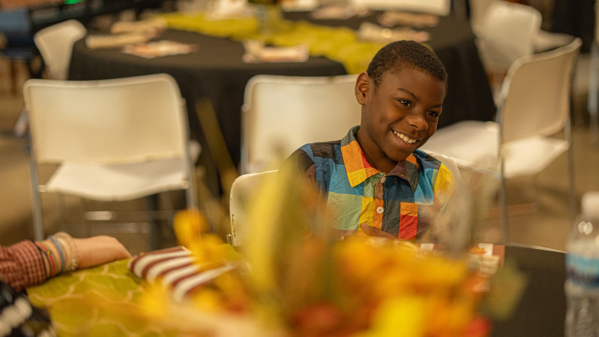 A child seated at a decorated table at Citychurch